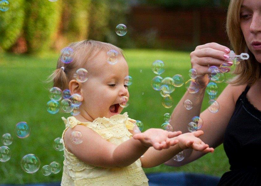 baby catching bubbles