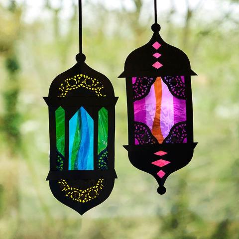 Black paper lanterns with colorful mosaic patterns.