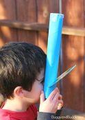 boy holding a homemade spectroscope