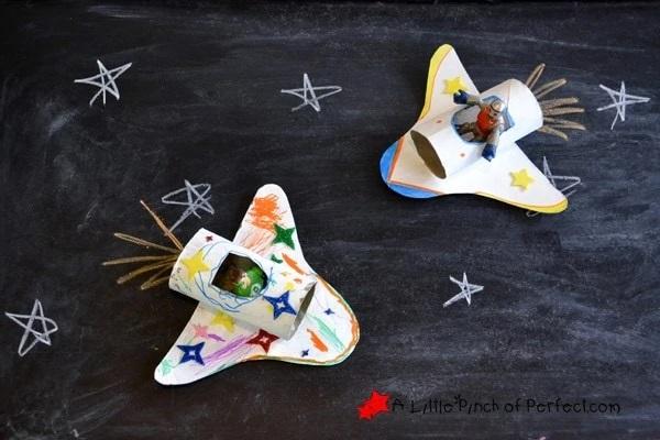 cardboard space shuttles on black background