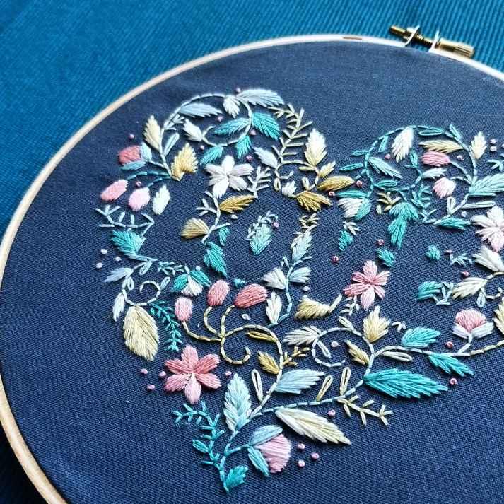 Picture of completed love embroidery pattern in variegated thread on blue fabric 