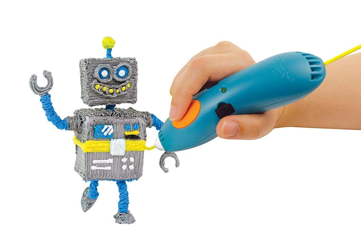 A hand using a teal 3D doodle pen to create a robot our of grey, yellow, and blue plastic filament.